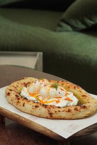 Turkish Egg Flatbread - Como Lounge Dubai dubai